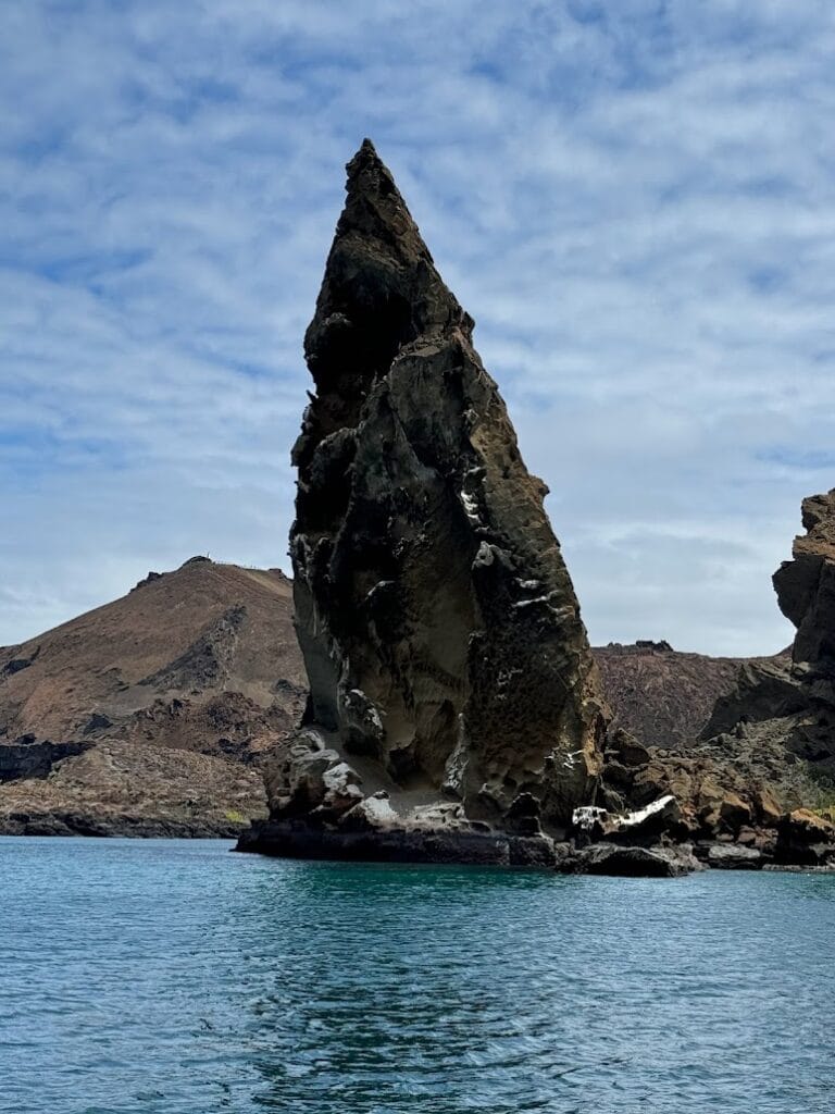 Pinnacle Rock at Bartolomé seen from a small boat under way, Galápagos
