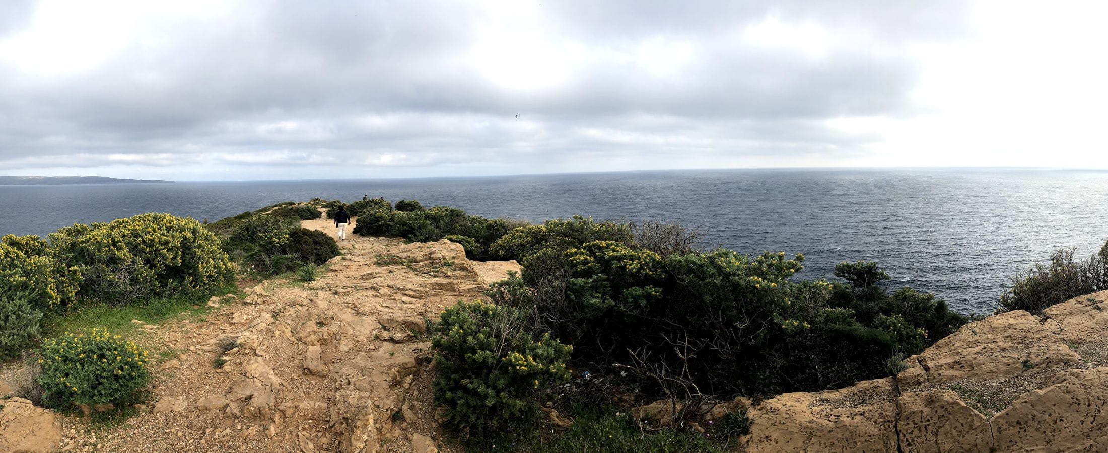 A headland path above the sea at Cape Sounion under a grey March sky