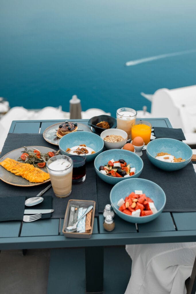Breakfast spread on a terrace table overlooking the sea