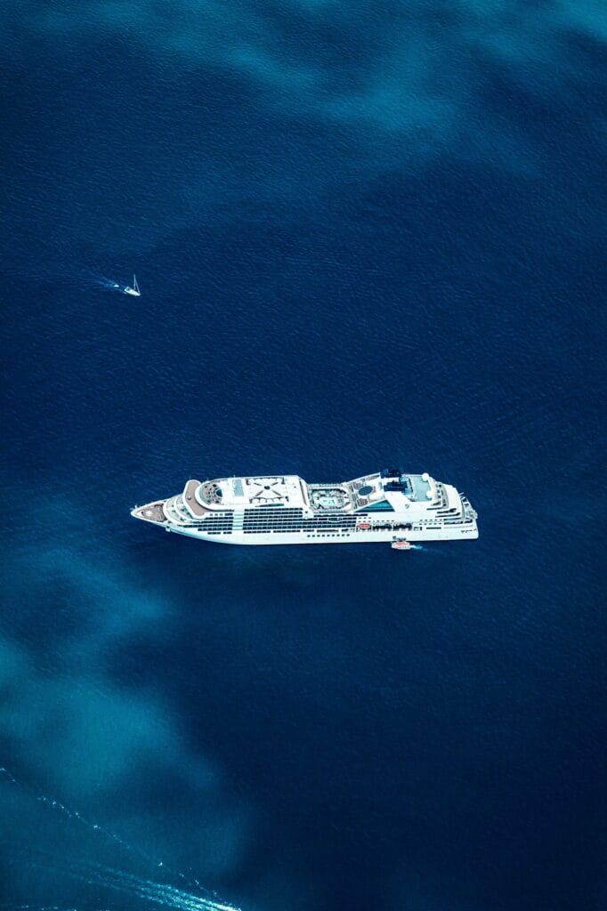 Aerial view of a cruise ship crossing deep blue open ocean