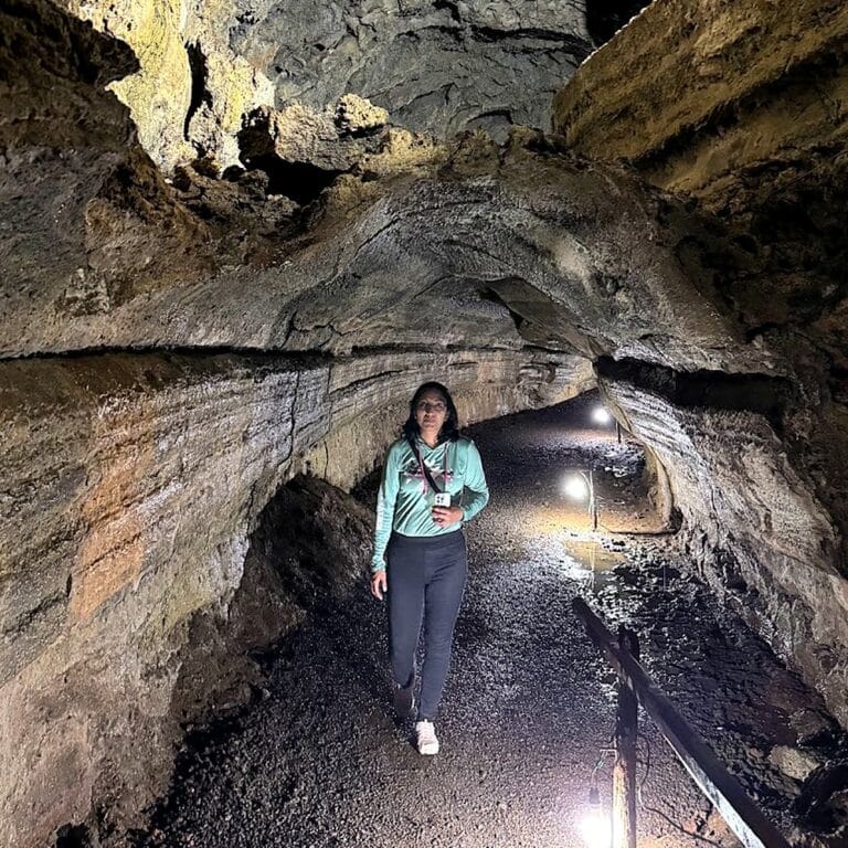 Traveler walking through an underground lava tunnel on Santa Cruz Island, Galápagos