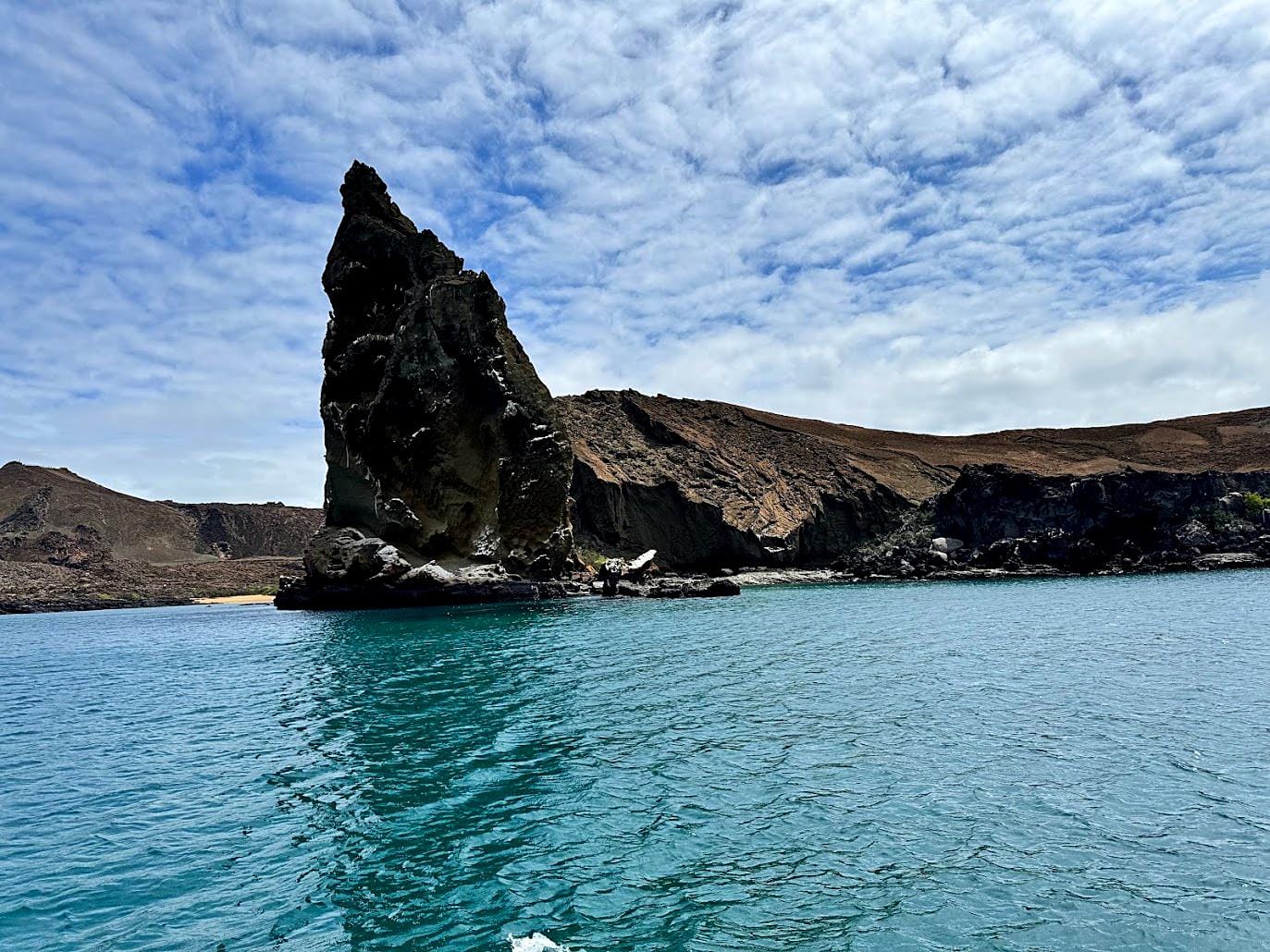 Pinnacle Rock rising above turquoise water on Bartolomé Island in the Galápagos, an iconic wildlife expedition-cruise landmark
