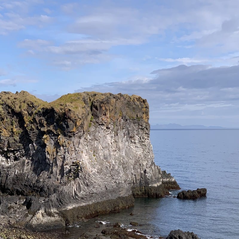 Basalt sea cliffs meeting the Atlantic at Hellnar on the Snæfellsnes peninsula, western Iceland