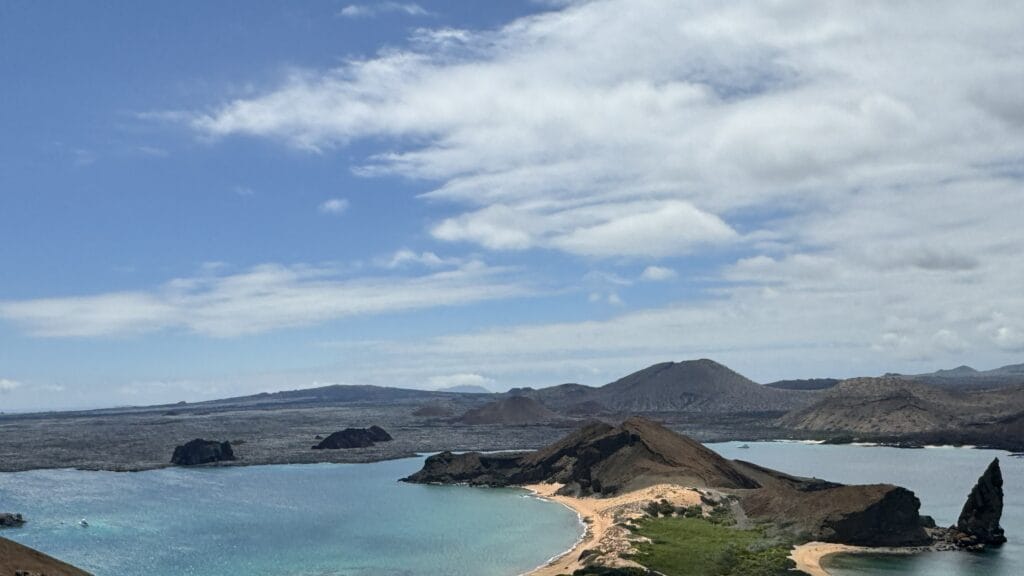 View from the Bartolomé summit in the Galápagos, with Pinnacle Rock, twin bays and volcanic cones on the horizon