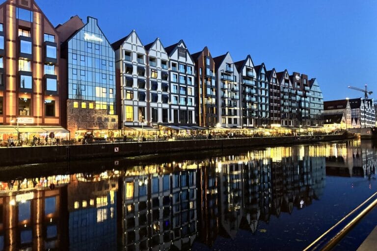 Illuminated Motława riverfront at dusk, Gdańsk, Poland