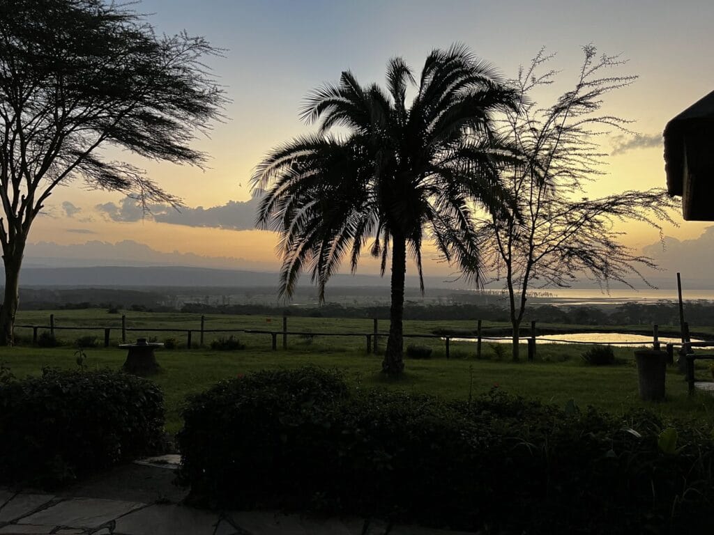 Sunset over a Rift Valley lake in Kenya seen from a safari lodge garden