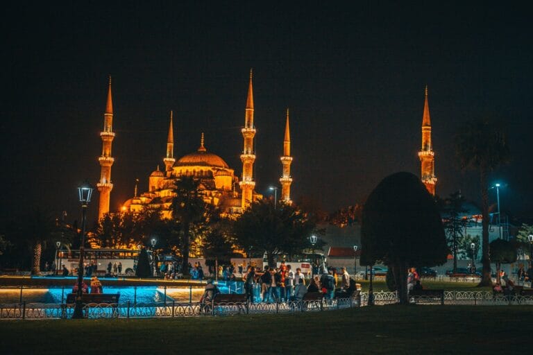 The six minarets of Istanbul's Blue Mosque lit up at night, seen from Sultanahmet Square