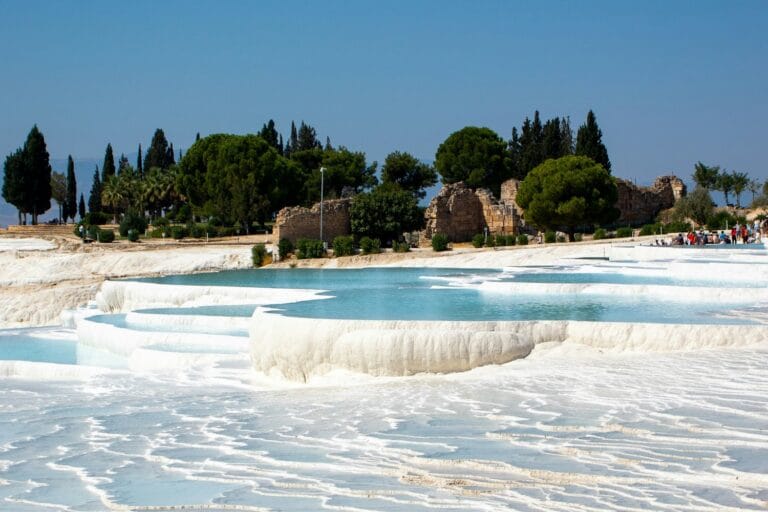 The white travertine terraces and warm thermal pools of Pamukkale, Turkey